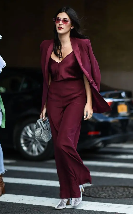 a chic party look with a cherry red top and pantsuit, silver boots and a silver bag is a bold idea to go for