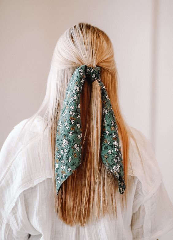 a classic half updo on straight hair, with a green floral scarf in the hair for a color touch