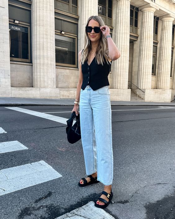 a cool summer look with a black waistcoat, bleached cropped jeans, black sandals and a black bag