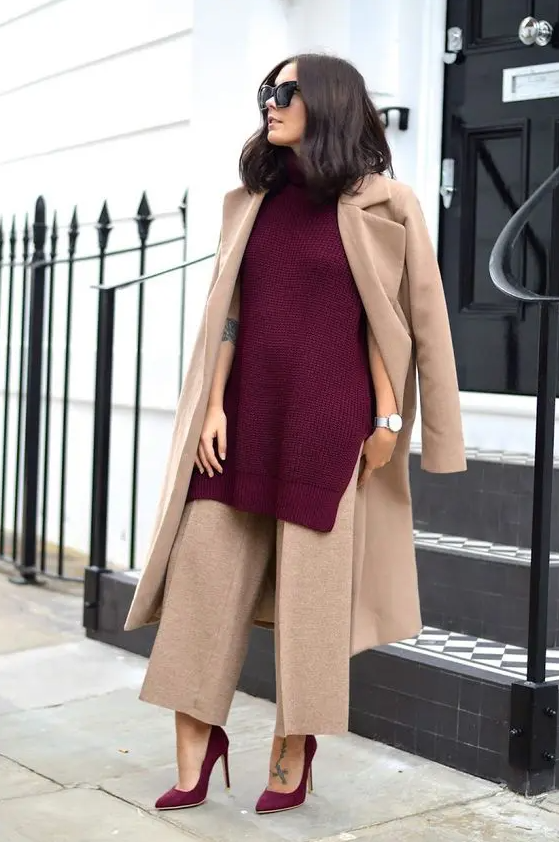a gorgeous work outfit with tan wide leg trousers and a trench, a cherry red knit sleeveless sweater and matching shoes