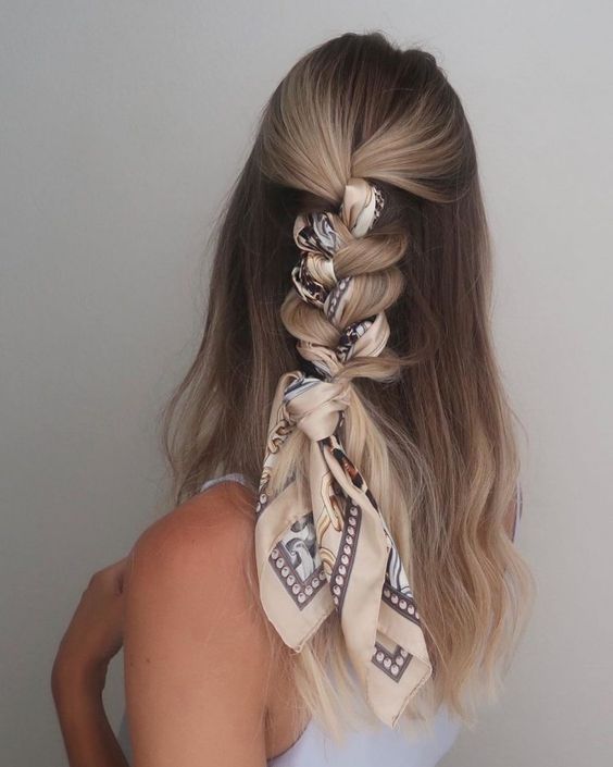 a lovely half updo with a volumetric top and a loose braid down plus a printed scarf to accent the braid is amazing