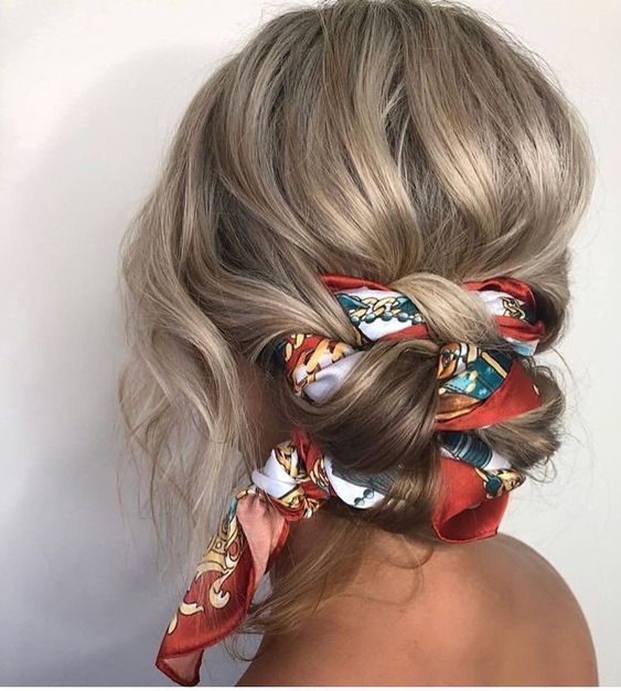 a lovely wavy low updo interwoven with a bright scarf, with a volumetric top and waves down is amazing