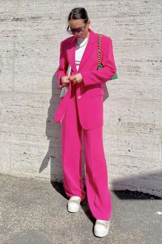 a magenta pantsuit with an oversized blazer, a white t-shirt, white sneakers, a green bag on chain are amazing for work