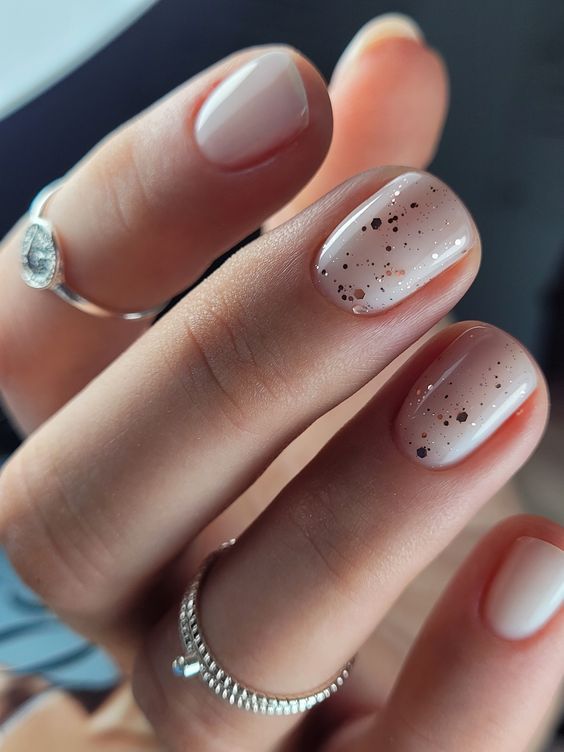 a milky manicure with gold foil pieces is a lovely and chic idea with a touch of shine, try one for spring or summer