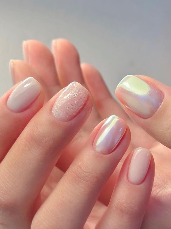 a milky manicure with some accents, a glitter and two iridescent nails, is a lovely and chic idea for spring or summer