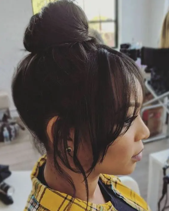 a pretty classic top knot with face-framing hair is always a good idea that will match many looks