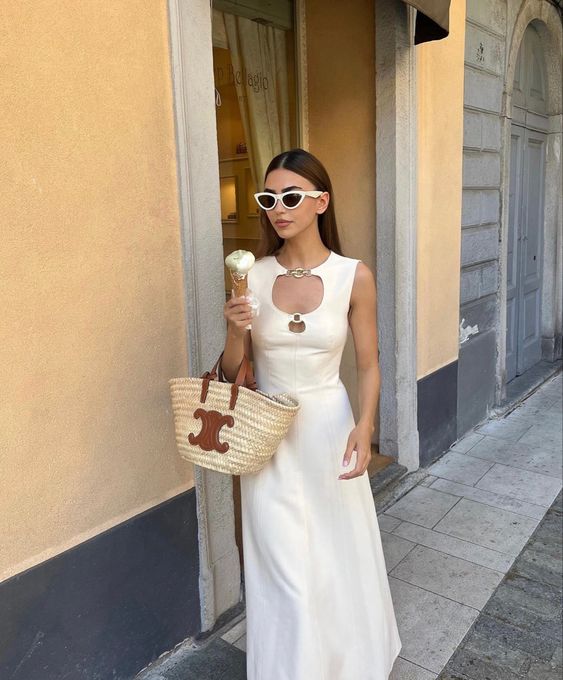 a pretty ivory maxi dress with a quirky neckline with metal detailing and a woven bag for a spring to summer bridal shower