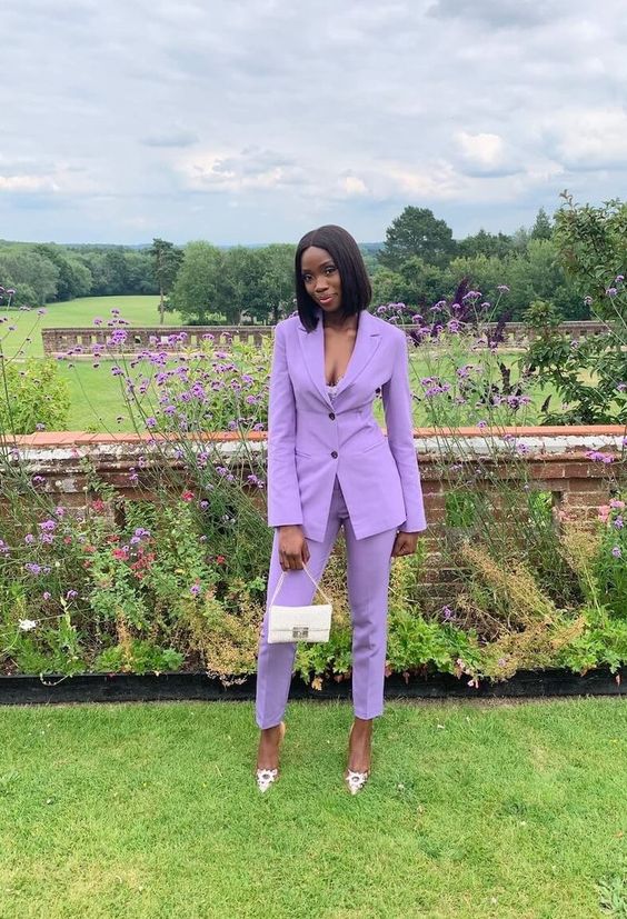 a purple power suit, embellished shoes and a small white bag are a lovely combo for the space, the color of the suit just wows