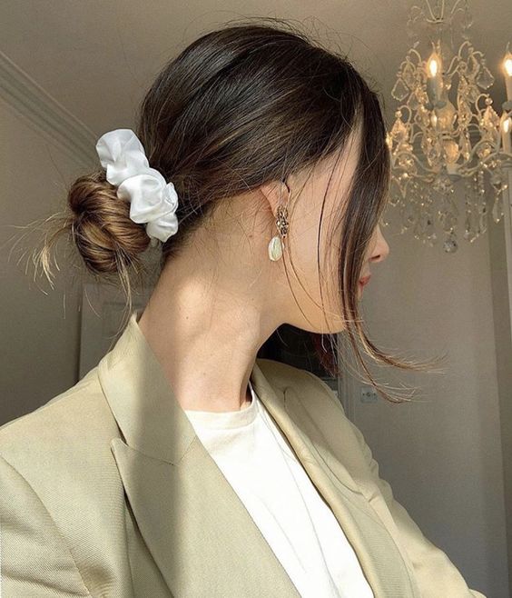 A simple twisted low bun with a volume on top and face framing hair is a lovely hairstyle to rock