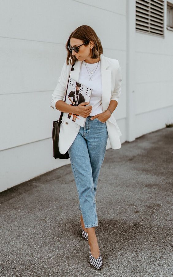 A spring work outfit with a white t shirt, a white blazer, blue jeans, gingham slingbacks and a black bag