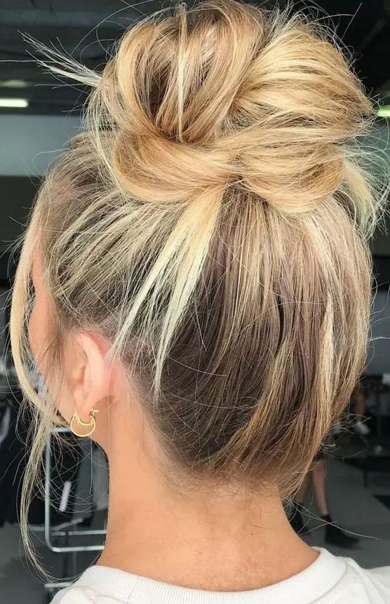 a very messy top knot on long hair, with some textured hair down is always a good idea to try