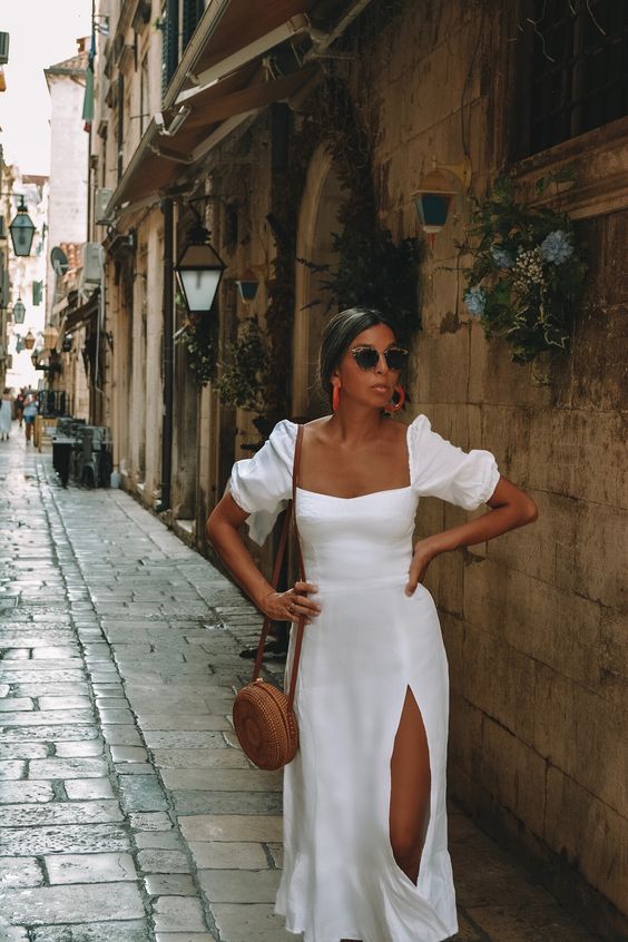 a white midi dress with puff sleeves and a thigh high slit is a perfect idea for a spring or summer bridal shower