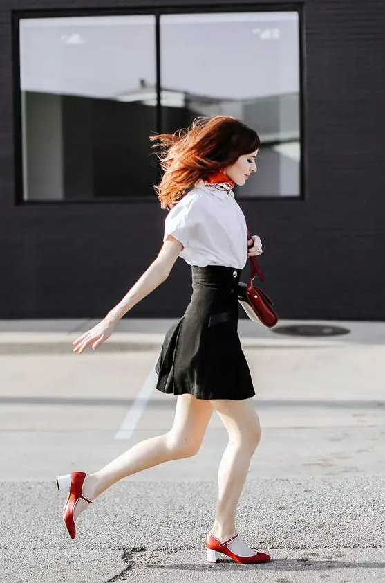 a white shirt, a black high waisted skirt, red Mary Jane shoes and a matching bag for the fall