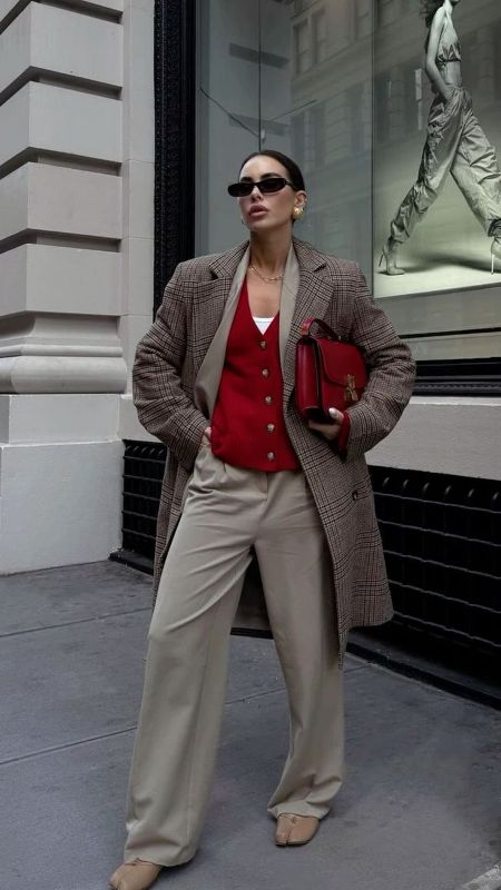 a white top, a cherry red cardigan and a bag, dove grey pants, a brown midi coat and statement earrings