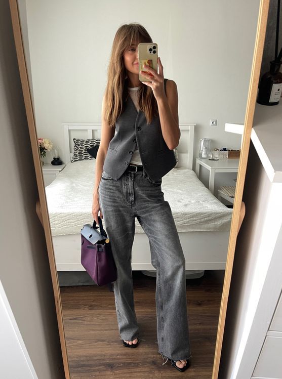 a white top, a grey waistcoat, grey jeans, sandals and a black and purple bag for an out of the box spring ot summer look