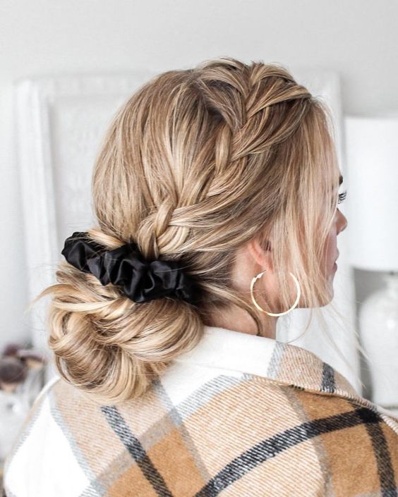 A wrapped low updo with a braid on one side and face framing hair is a cool hairstyle to try on long hair