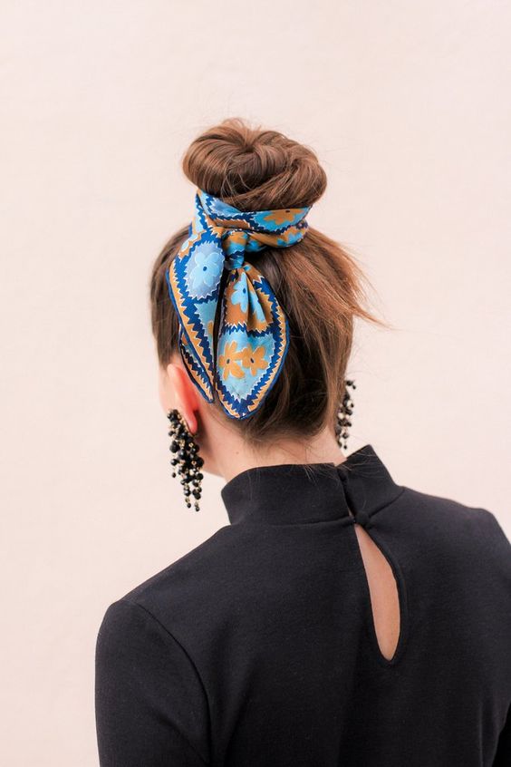 An elegant ballerina top knot accented with a bold blue printed scarf is a super cool and eye catchy idea to rock