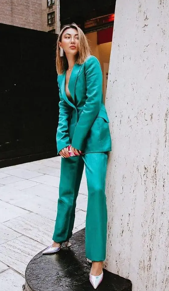 an emerald pantsuit with a long blazer, pants, pink shoes and statement earrings is a catchy look to rock