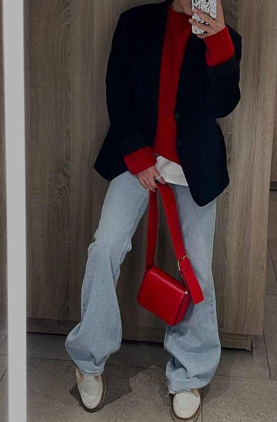 an every day look with a white t-shirt, a red jumper, a black blazer, bleached jeans, white sneakers and a cherry red bag