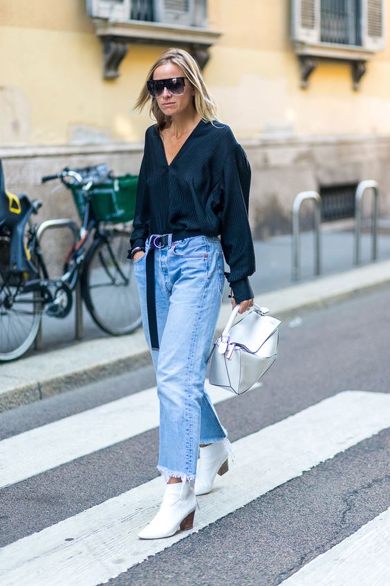 blue jeans with fringe, an oversized black button down, white boots and a white bag plus a long black belt