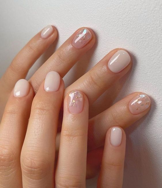 extra short milky nails with accent ones done in blush and with metal foil are amazing, and this whimsy touch adds to the look
