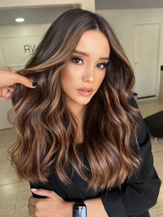 fab long dark brunette hair with slight caramel contouring and volume and waves looks jaw-dropping