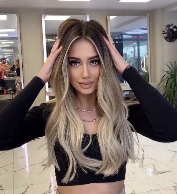 long brunette hair done with blonde contouring and ombre for a bold and eye-catchy look that wows