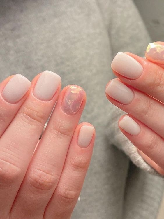 milky nails with accents done with glazed donut blush are creative and bold