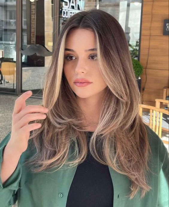 mousy brown medium-length hair with blonde contouring, layers and waves is amazing