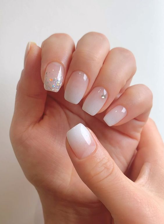 ombre milky nails with rhinestones and glitter are very glam, lovely and chic and they look amazing