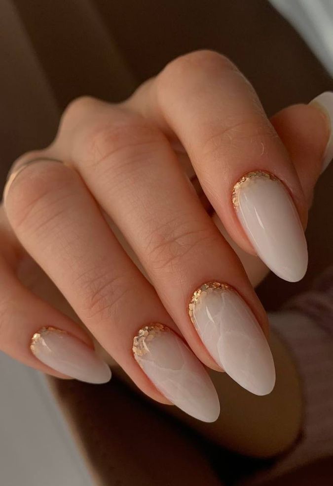 refined and chic milky marble nails with gold glitter are amazing and will make a sophisticated statement in the look