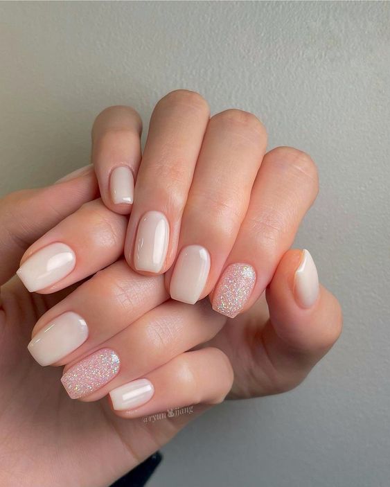 shiny milky nails with two accent ones, with pink glitter, are amazing to look chic and pretty every day