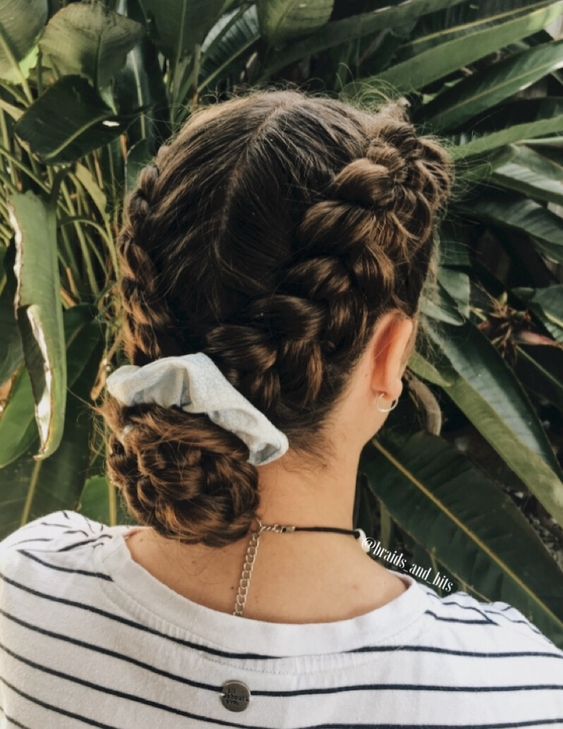 two braids on top and a low bun of them secured with a neutral scrunchie are a lovely hairstyle