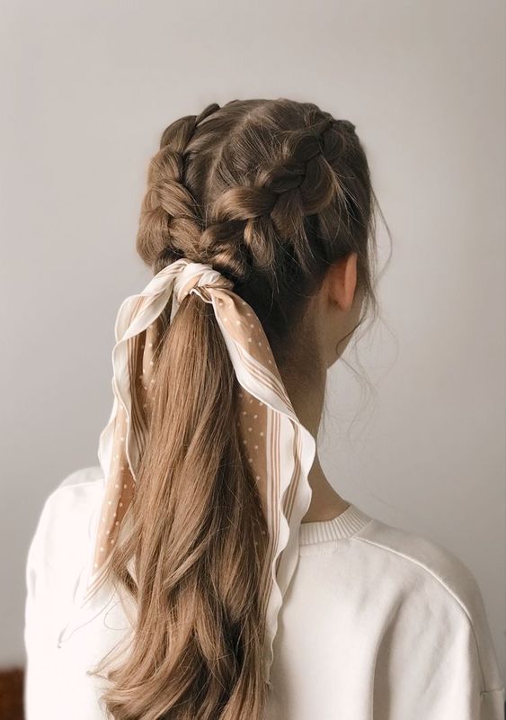 two side braids into a low ponytail with a bit wavy hair and a polka dot scarf as an accessory