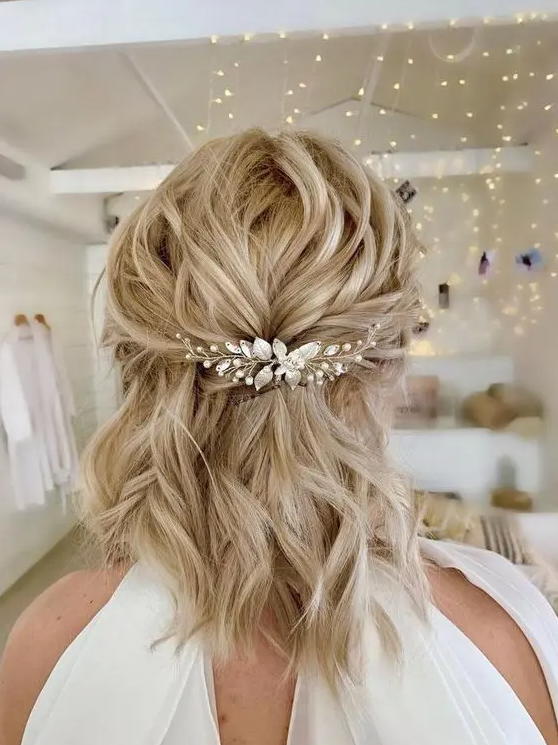 a beautiful and easy half updo with wavy hair and an embellished hair piece is a chic idea to rock to a wedding