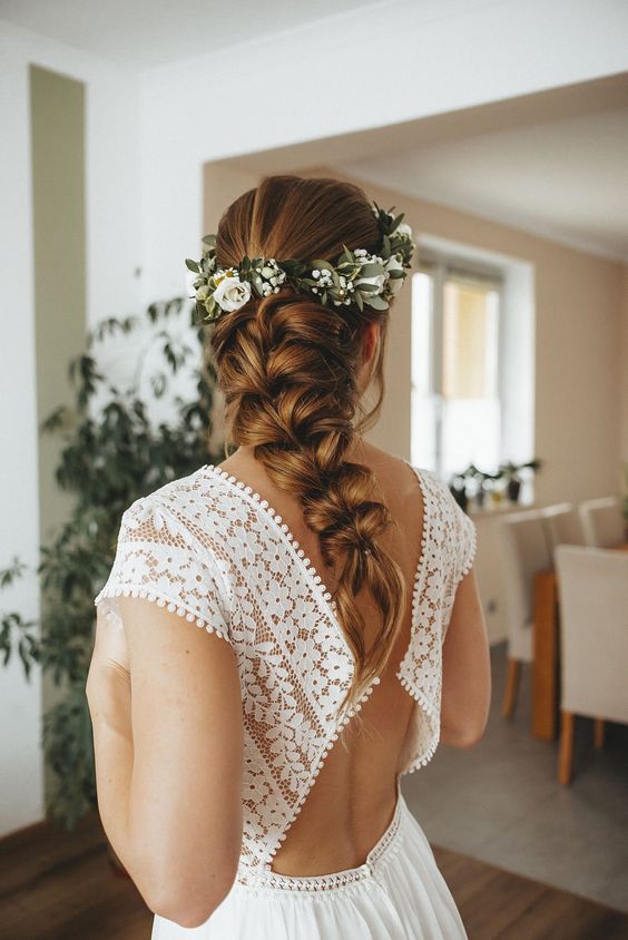 a beautiful loose braid with an additional floral hair crown is a chic and cool idea for a rustic wedding