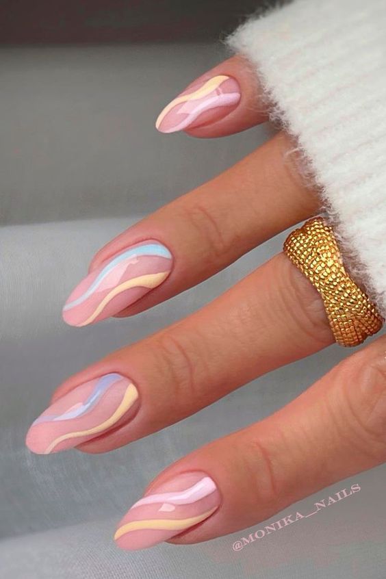 a beautiful spring swirl manicure done in blush, pastel blue and yellow is a cool way to look very up-to-date