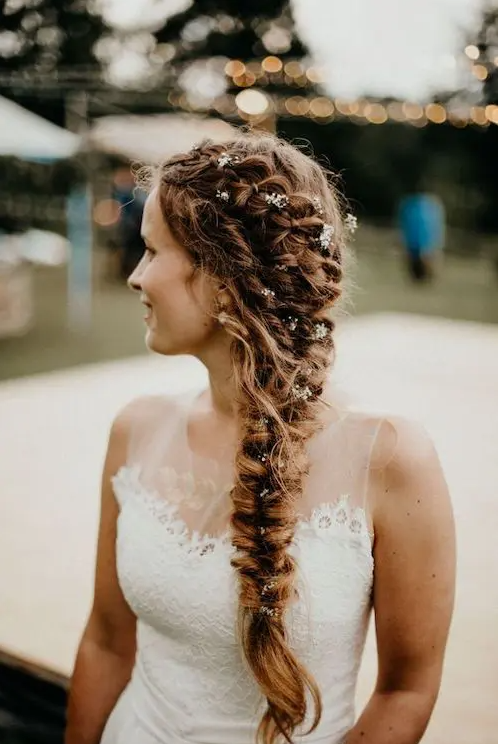 a beautiful thick braid composed of several braids and with small blooms tucked into the hairstyle is a very cool idea