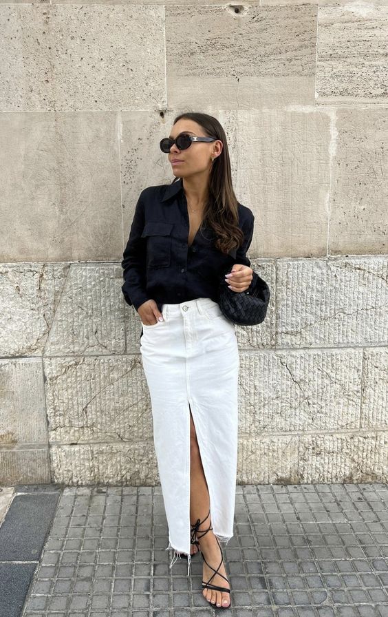 a black button down, a white denim maxi skirt, black strappe shoes and a small hobo bag