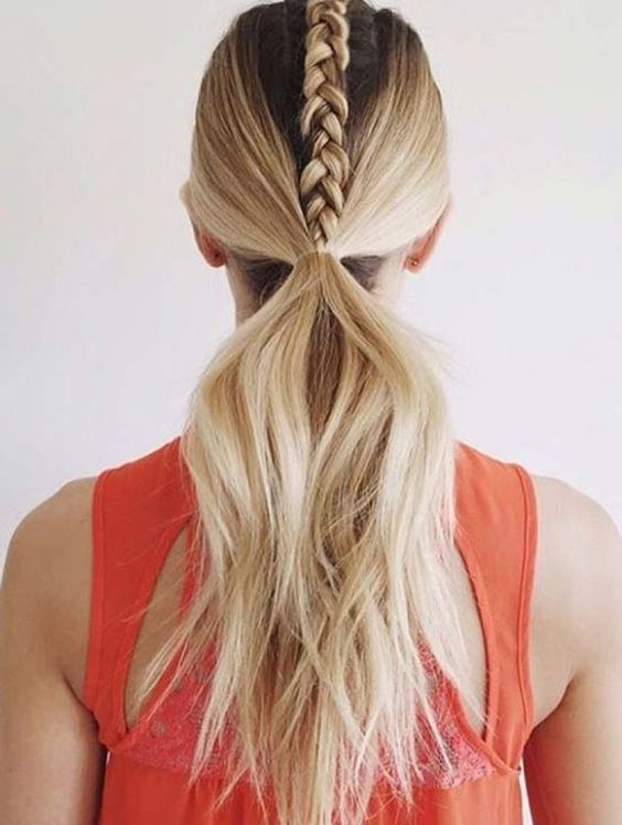 a braid on top and a low ponytail are a cool and creative hairstyle for the gym or a workout