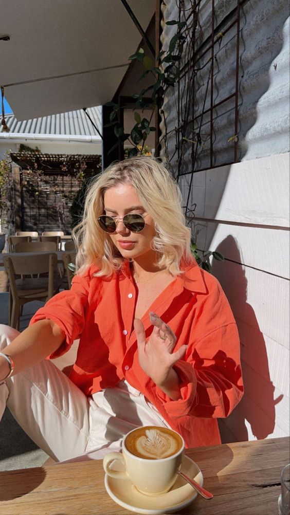 a bright orange button down plus white jeans are a super cool combo for spring or summer