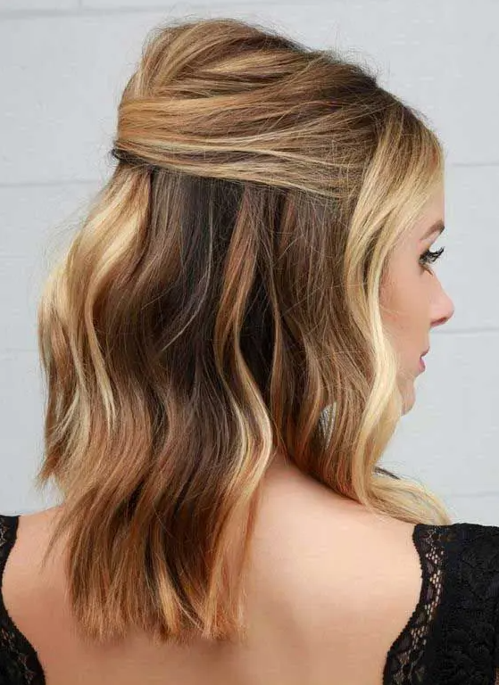 a chic and sexy half updo with a bump on top and wavy hair down is a cool solution for a more casual yet sexy look