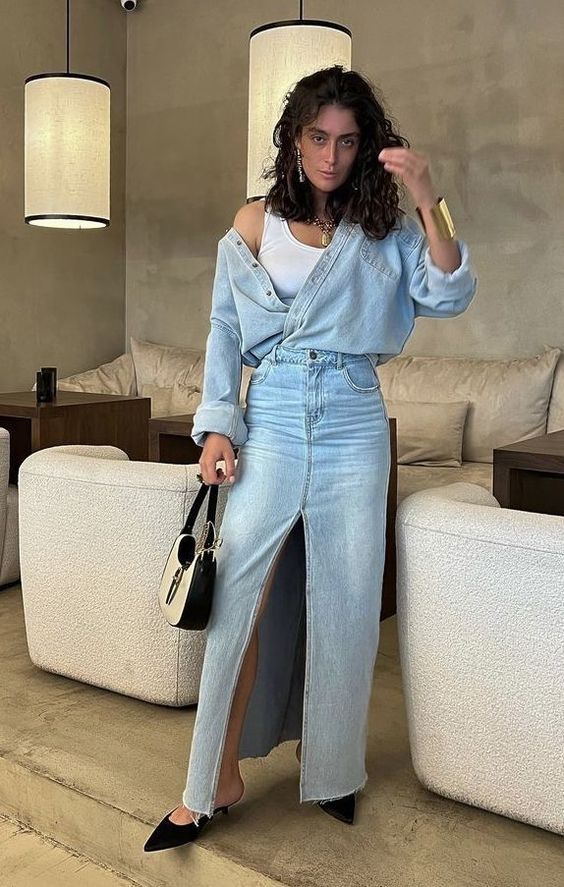 a chic double denim look with a white tank top, a bleach denim maxi, a chambray shirt, black heeled mules and a two-tone baguette bag