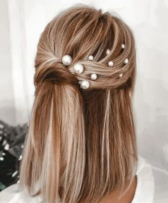 a chic twisted half updo with multiple pearl hair pins and straight hair down is a cool idea