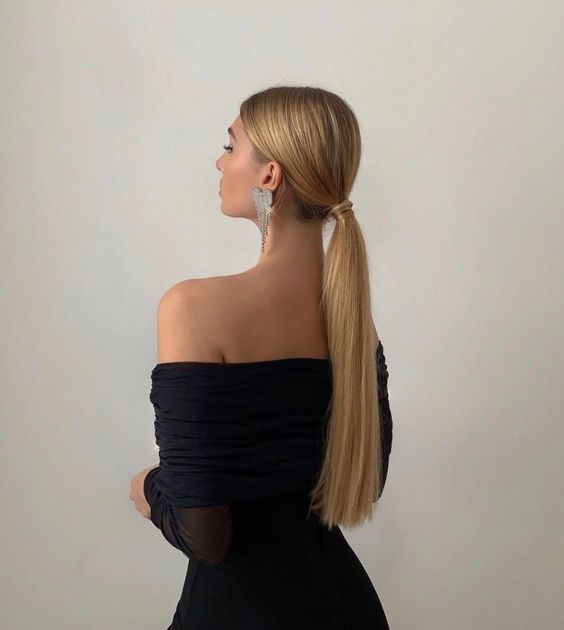 a classy and elegant low ponytail with a sleek top is a cool and catchy idea for a modern or minimalist bride