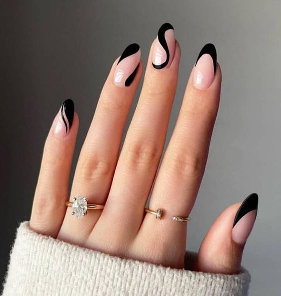 a classy blush and black French manicure with tree nails done with swirls is a cool and catchy idea to look different