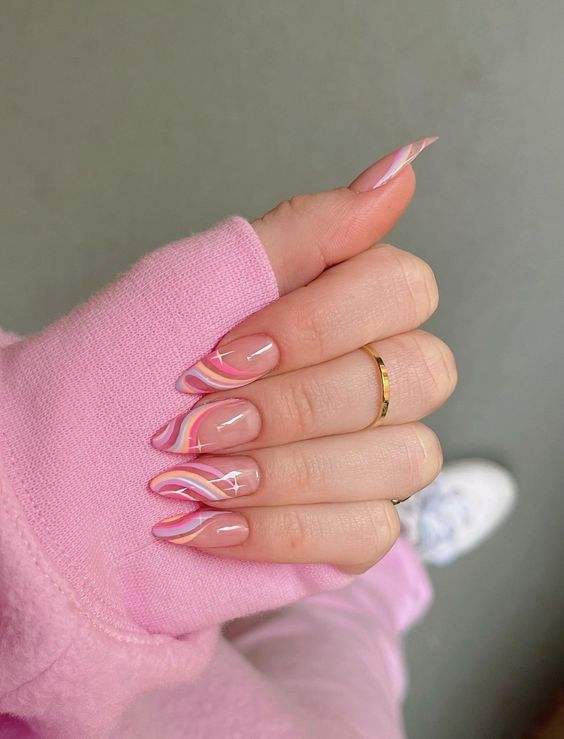 a colorful swirl manicure done in pastel pink, yellow and blue, with hot pink touches is cool for spring and summer