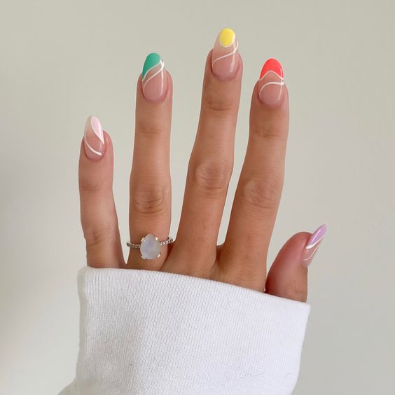 a colorful swirl manicure done in white, yellow, green, pink and red, is a cool and chic solution for the summer