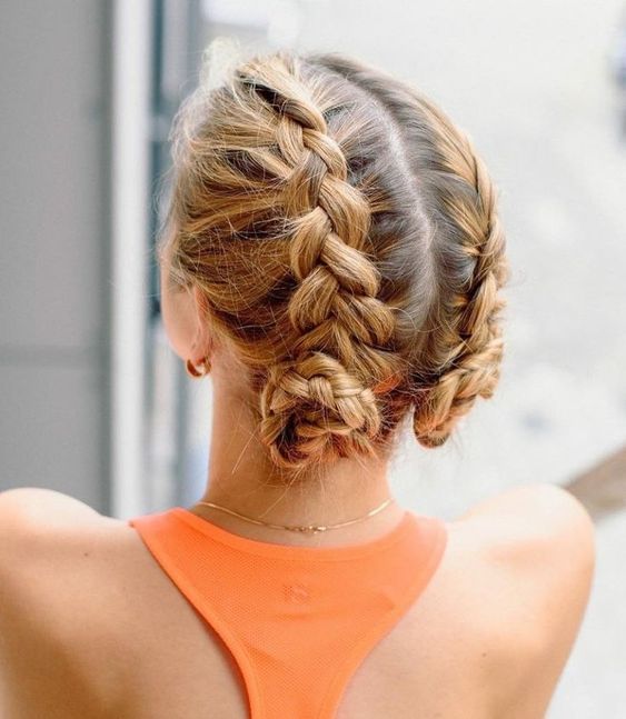 a comfy sporty hairstyle with two braids on top the head fixed as low buns is a cool and cute idea