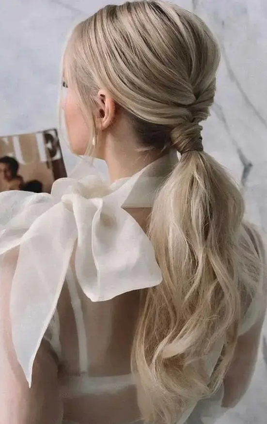 a cool and chic ponytail with a bump on top and volumetric hair, with hair wrapping the face is amazing